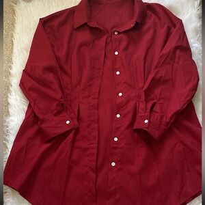 Burgundy dress shirt with white buttons.